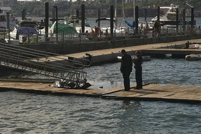 Investigators with the body at the West 79th Street Boat Basin